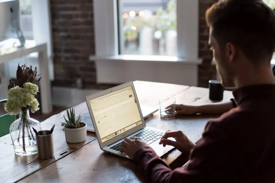 A man works on a laptop